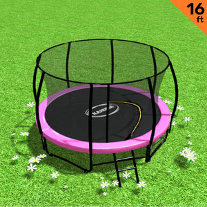A 16 foot round trampoline with a pink padding cover, safety enclosure net, and a steel ladder placed on grass with daisies around.