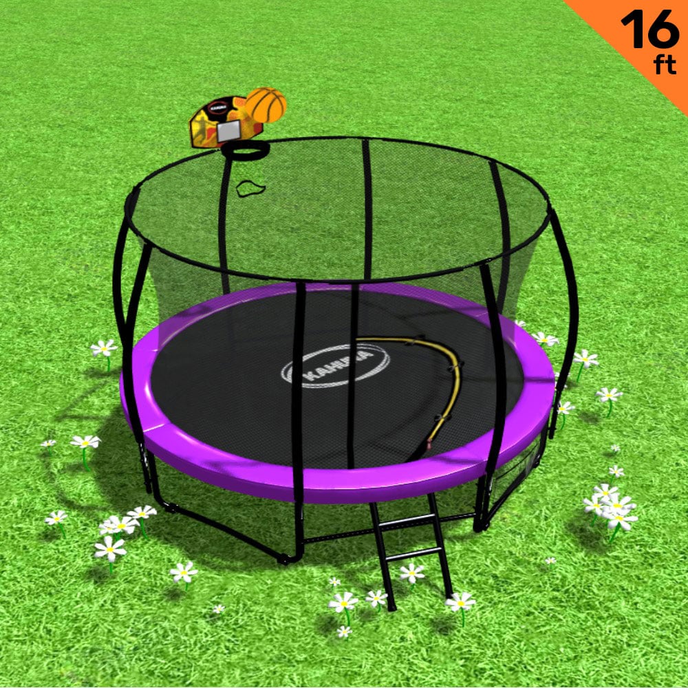 A 16ft outdoor trampoline with a safety enclosure pad, ladder, and basketball hoop set. The trampoline is purple and black with a visible Kahuna brand logo, placed on a grassy surface with flowers around it.