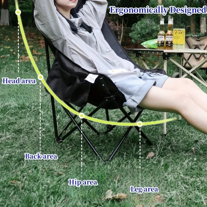 Person sitting on a camping chair with ergonomic design labeled, outdoors.