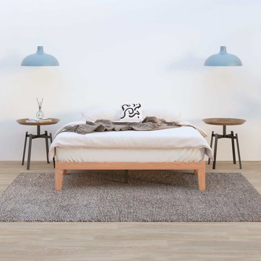 Bedroom with a wooden bed, side tables, and pendant lights.