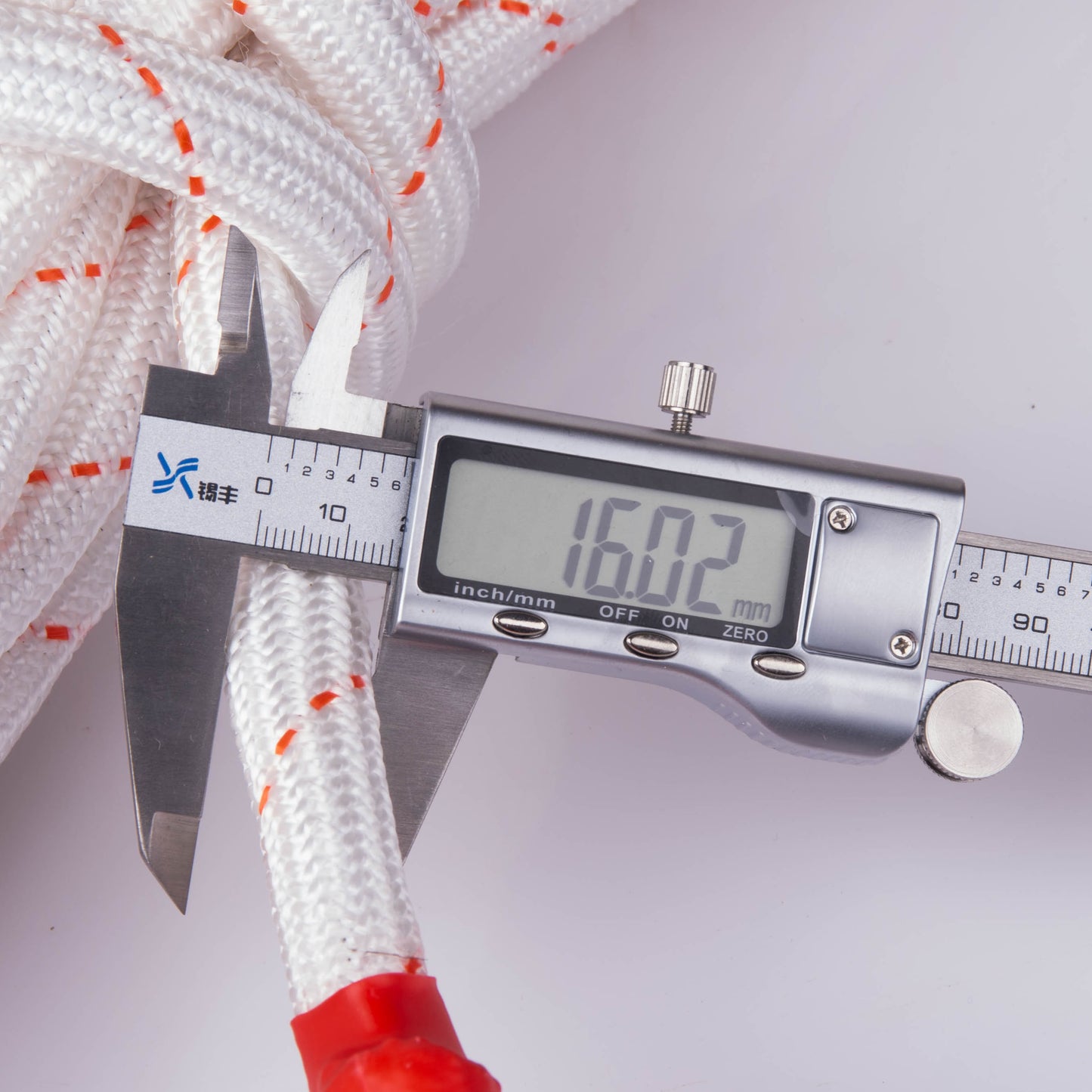 Digital calliper measuring a white Climbing Rope with red accents on a white background