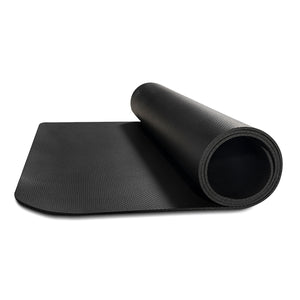Black yoga mat rolled up on a white background
