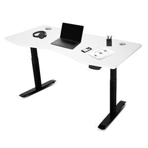 An automatic standing desk with white tabletop and black steel frame, equipped with grommets for cable management, and preset height levels. The desk is shown in a partially adjusted position.