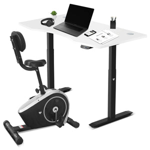 An exercise bike with an attached desk, in white and black colors, showcasing the bike's console and the beginnings of a setup for a workspace.