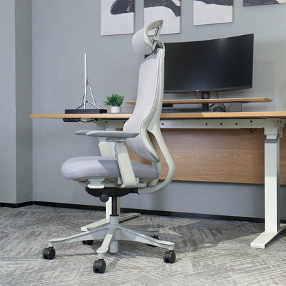 Ergonomic office chair in a modern office setting with a desk and computer setup.
