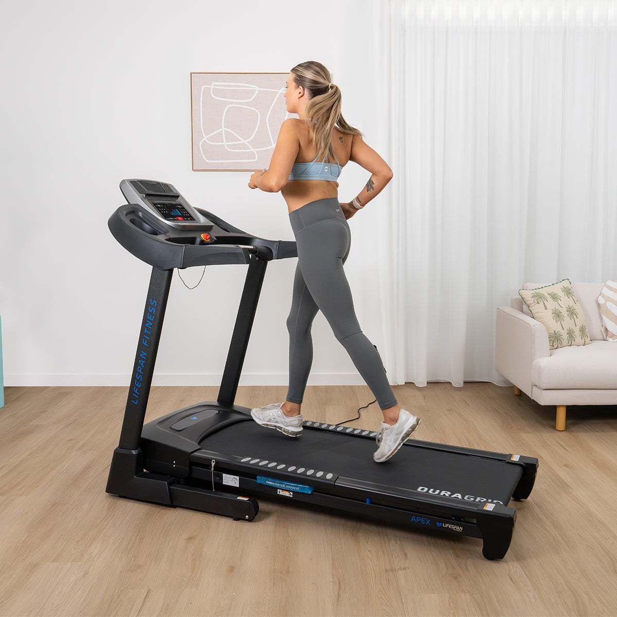 Woman using a treadmill in a home setting