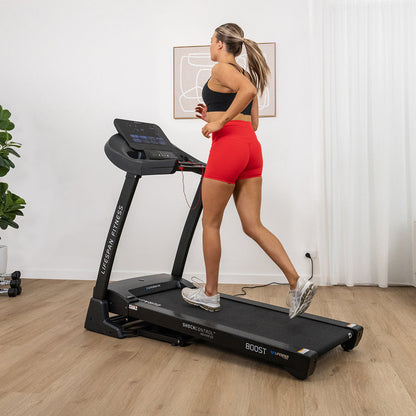 Woman running on a treadmill in a home setting