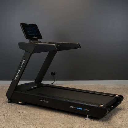 Black treadmill with digital display on a gray background