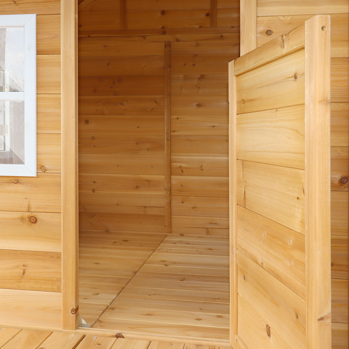 Wooden cabin interior with a partially open door