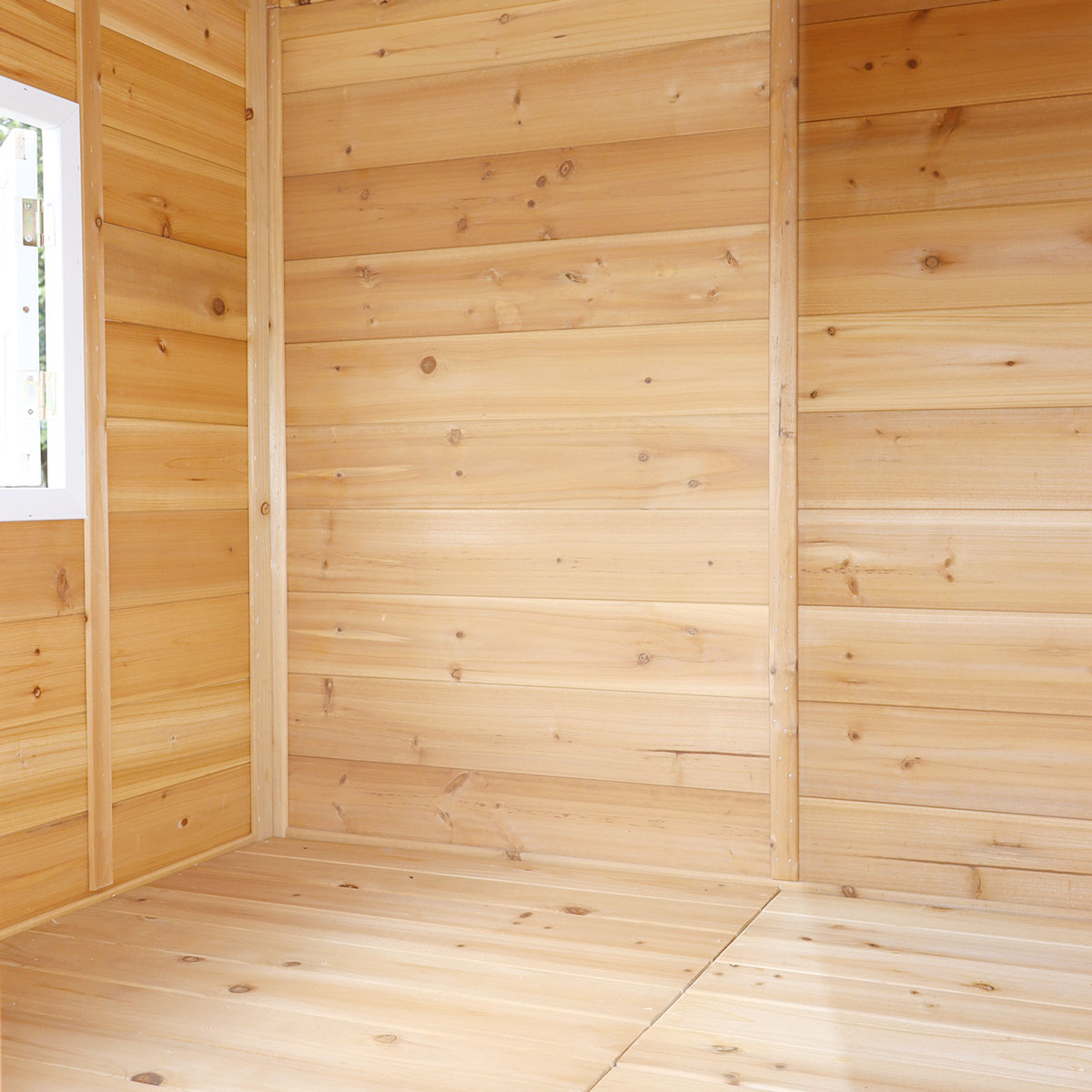 Wooden shed interior with light brown wooden panels.
