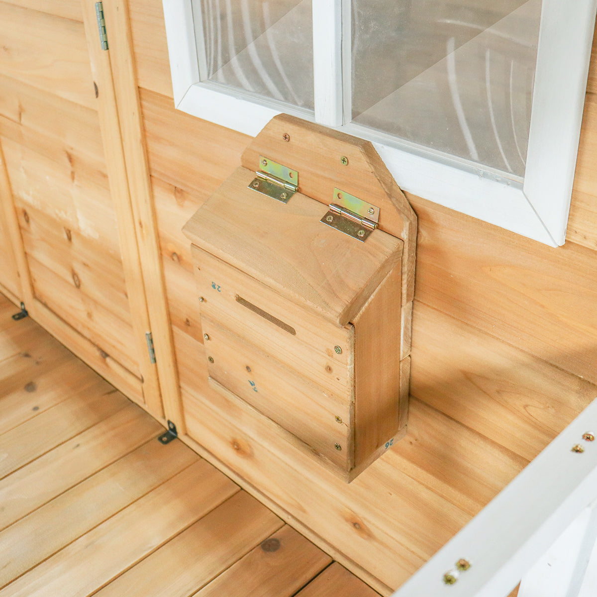 Wooden storage box attached to a wooden wall with a window above