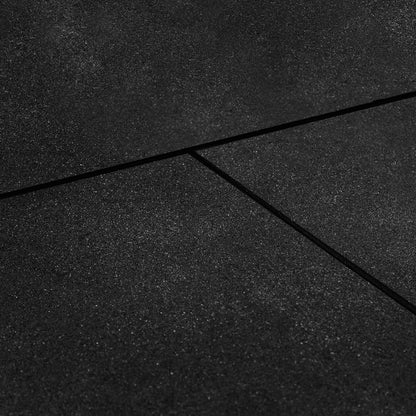 Close-up view of a black  rubber gym tile mat with a bevelled edge, showing the textured surface and slight crevice between mats.