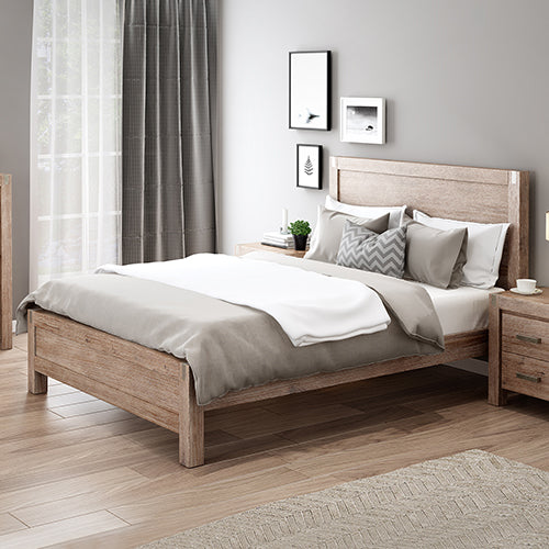Wooden bed in a bedroom with neutral decor