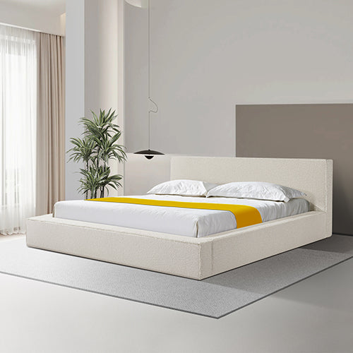 Modern white bed with yellow blanket in a minimalistic bedroom