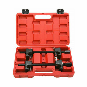 Two coil spring compressor clamps are displayed inside an open red storage case. The clamps are black with metal construction and have a center screw and side handles.