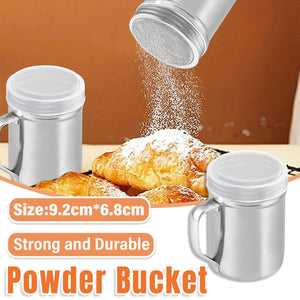 Metal powder shaker being used to dust croissants with powdered sugar on a wooden surface.