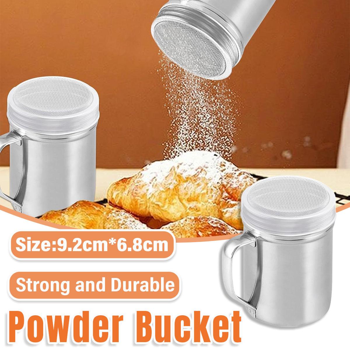 Metal powder shaker being used to dust croissants with powdered sugar on a wooden surface.
