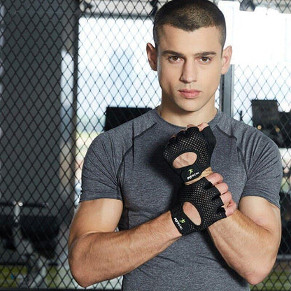 Man wearing a black boxing glove in a gym setting