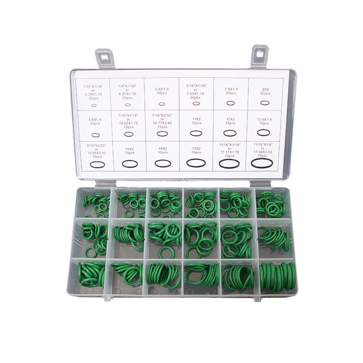 Set of green washers in a clear plastic case with measurement chart on a white background