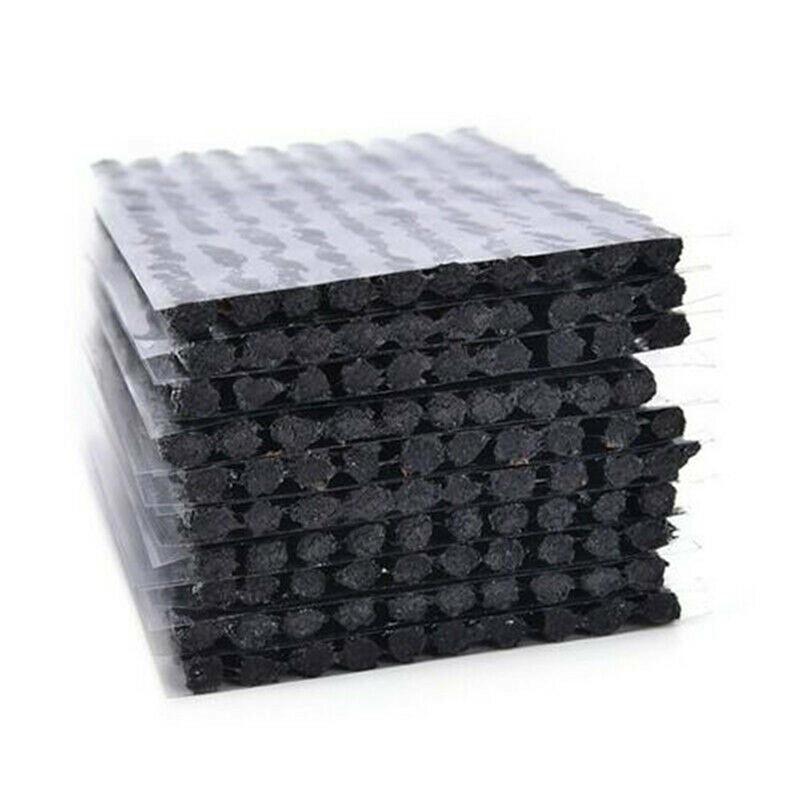 Stack of black tyre Repair Plugs with textured surface on a white background
