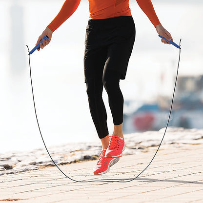 Person jumping rope on a wooden dock with a blurred background