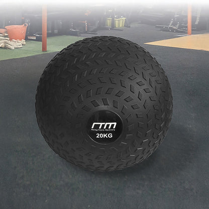 Black exercise ball with '20KG' marking on a gym floor