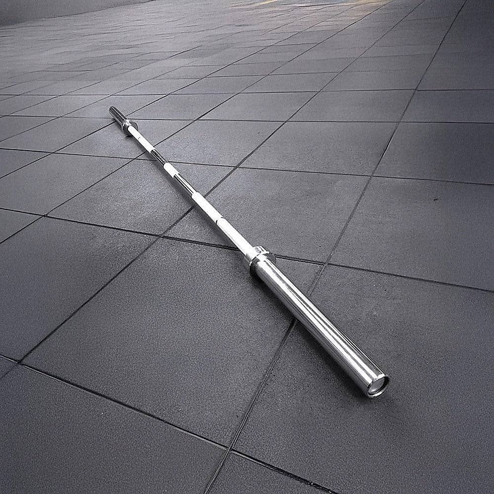 Metallic barbell on a tiled floor