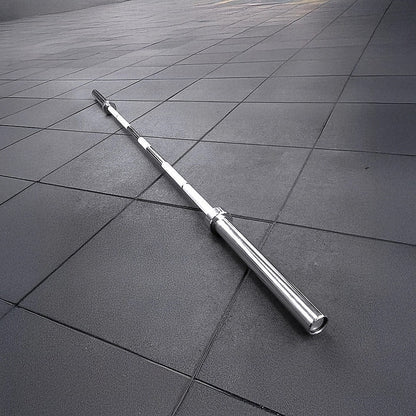 Metallic barbell on a tiled floor