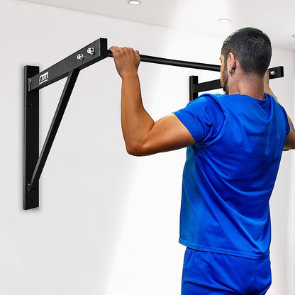 Person using a wall-mounted pull-up bar against a white wall