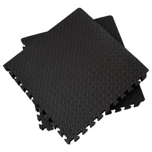 Black foam puzzle mats on a white background