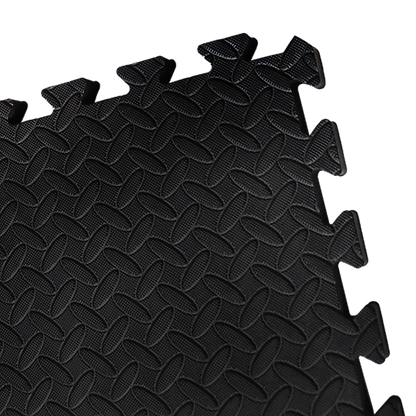 Black interlocking foam mats on a white background