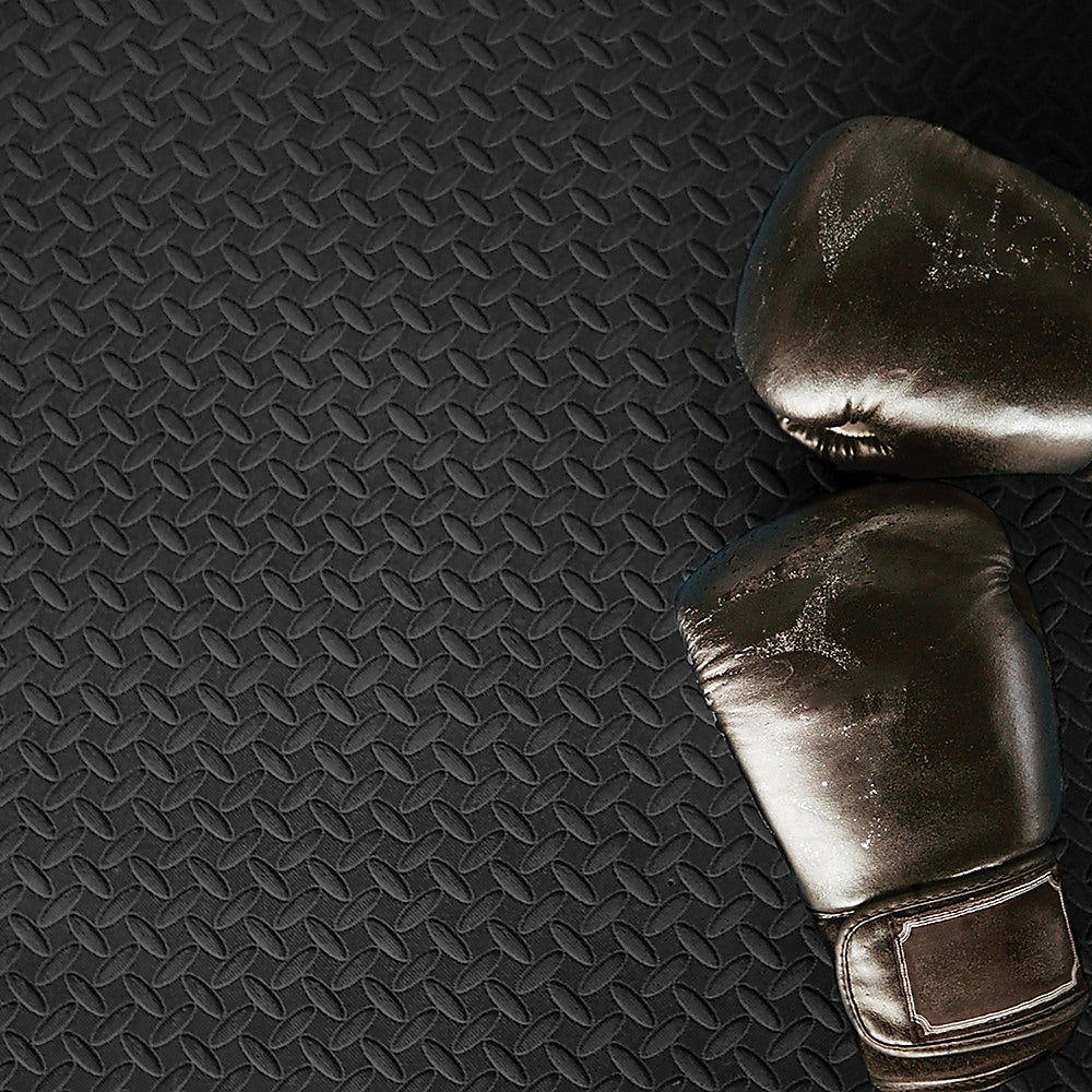 Pair of boxing gloves on a textured black surface