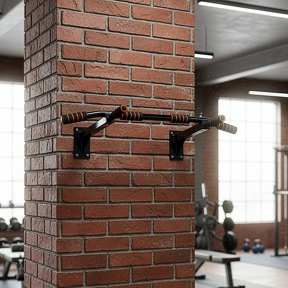 Pull-up bar attached to a brick wall in a gym setting