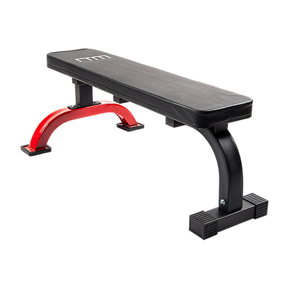 Black weight bench with red leg extensions on a white background
