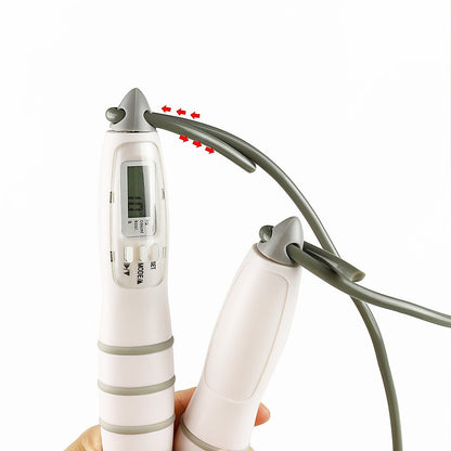 Digital thermometer held by a hand with a white background