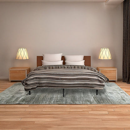 Bedroom with a bed, nightstands, and lamps on a wooden floor.