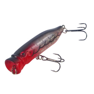 Fishing Popper lure with red and black body on a white background