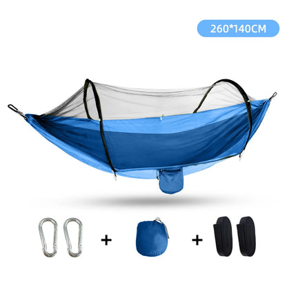A blue outdoor camping hammock with mosquito net, including two metal carabiners, adjustable tree straps, and a compact storage pouch.