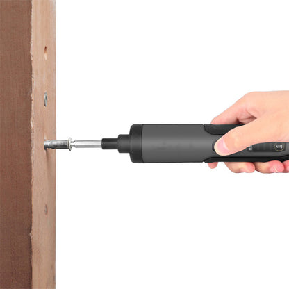 Hand holding a black screwdriver tool against a white background