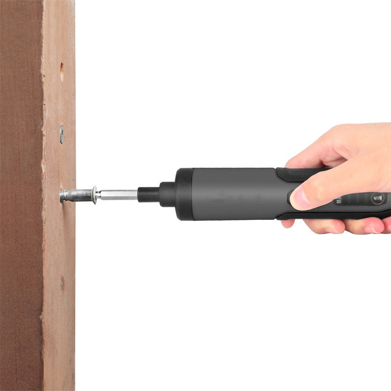 Hand holding a black screwdriver tool against a white background
