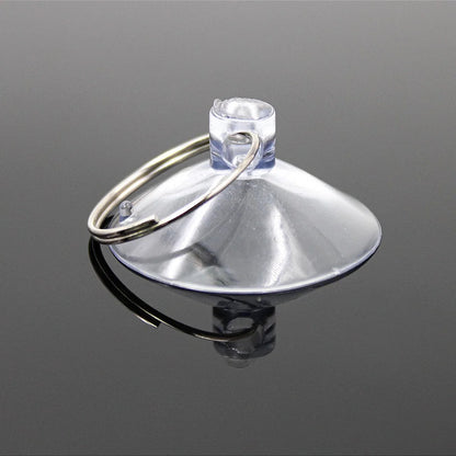 Metallic funnel-shaped object with a keyring on a reflective gray surface