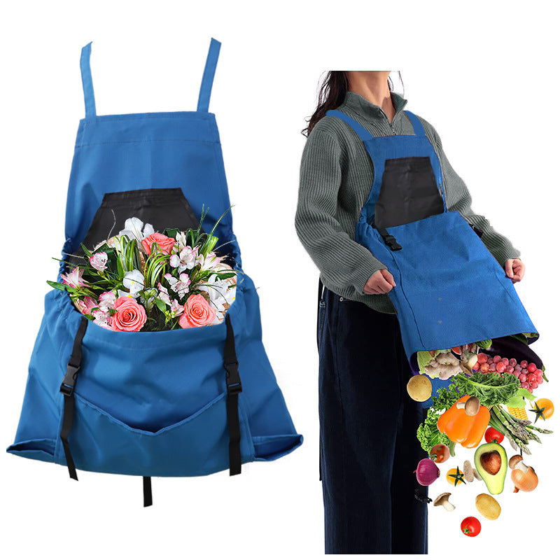 Blue apron with floral arrangement on one side and vegetables on the other, worn by a person.