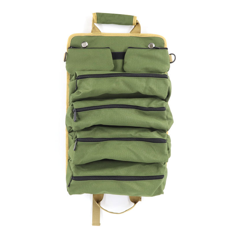 Green backpack with multiple pockets and zippers on a white background