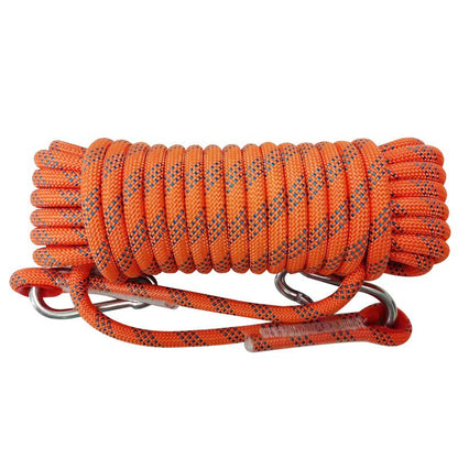 Coiled orange Camping Clothesline rope with metal carabiners on a white background