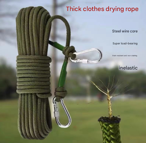 Green thick Camping Clothesline rope with carabiners on a blurred natural background