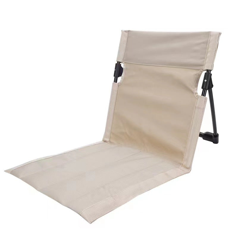 Beige folding beach chair on a white background