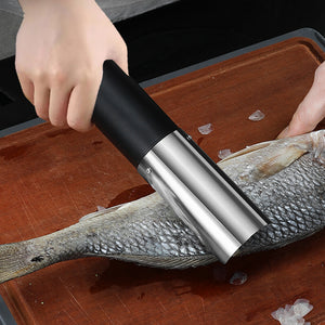 Electric Fish scaler being used on a fish on a wooden cutting board