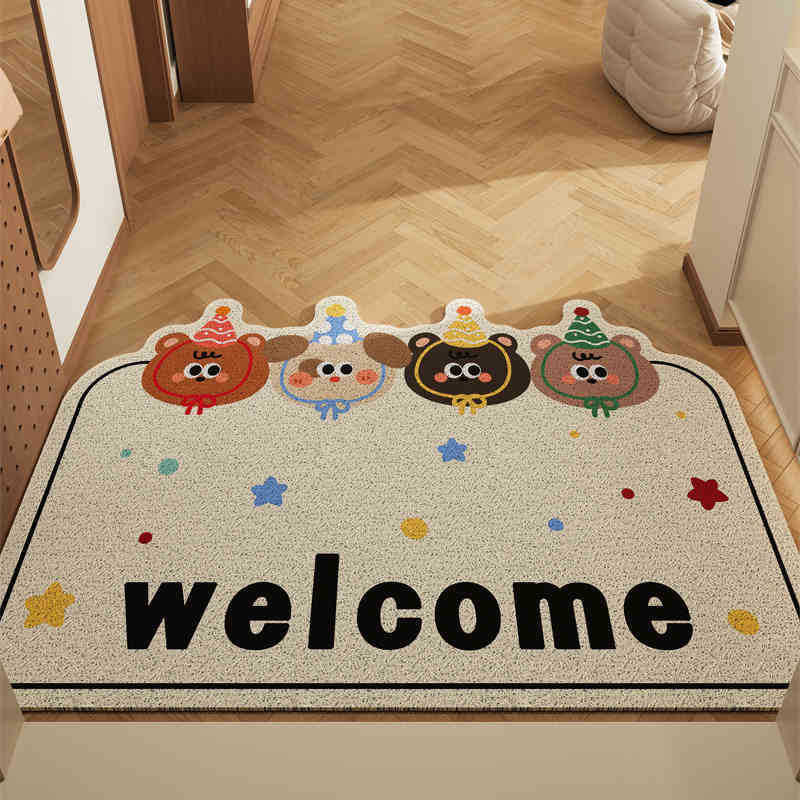 Decorative doormat with cartoon characters and the word 'welcome' on a wooden floor.