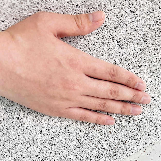 Hand resting on a textured white surface