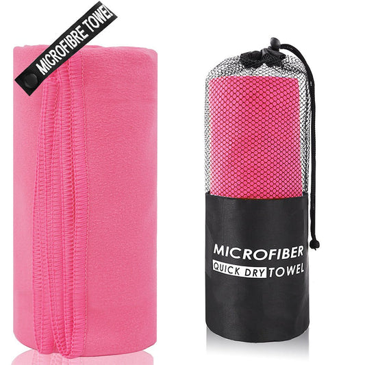 Pink microfibre quick dry towel with black carrying case on a white background